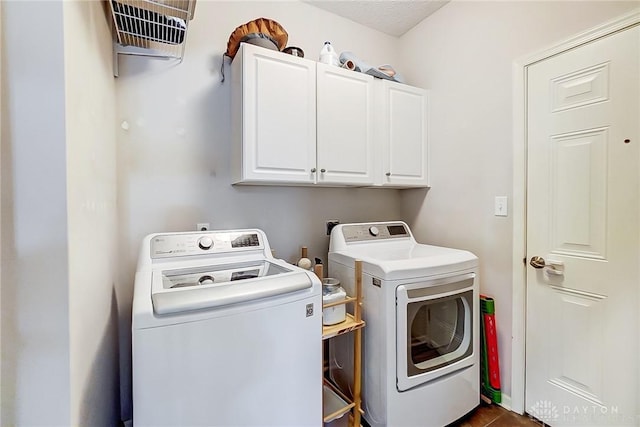 laundry room featuring cabinets and washer and dryer