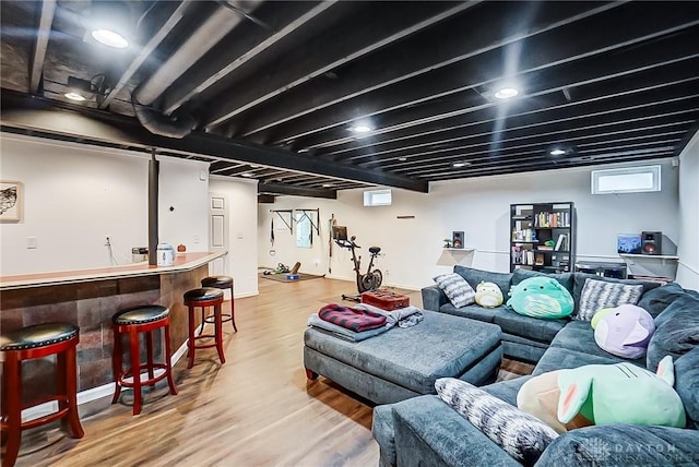 living room with bar area and light hardwood / wood-style floors