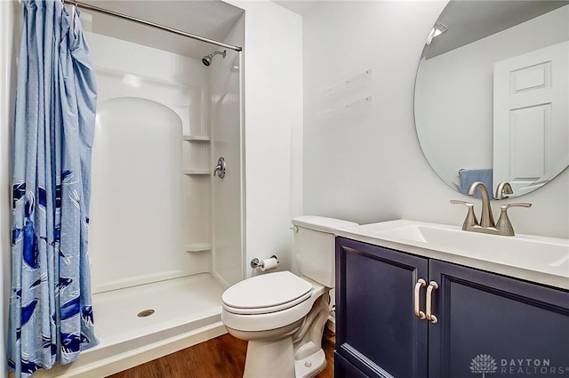 bathroom featuring a shower with curtain, toilet, vanity, and hardwood / wood-style flooring