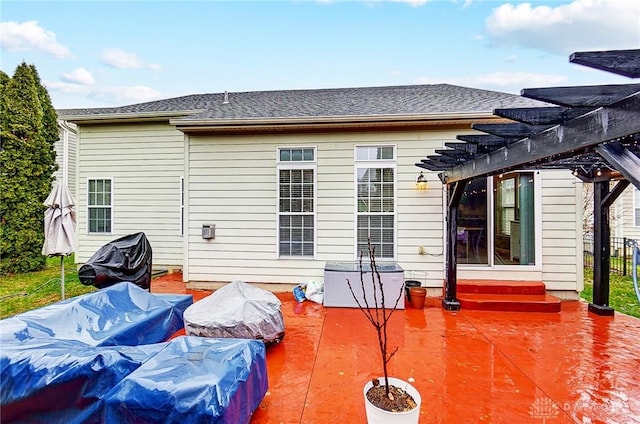 rear view of house with a pergola and a patio