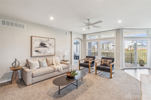 living room with ceiling fan and light carpet