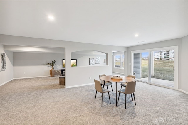 dining space with light colored carpet