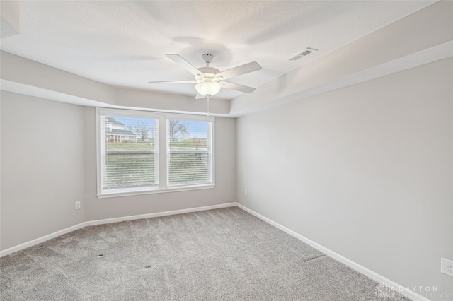 empty room featuring light carpet and ceiling fan