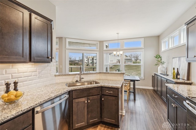 kitchen featuring dark hardwood / wood-style flooring, sink, a healthy amount of sunlight, and appliances with stainless steel finishes