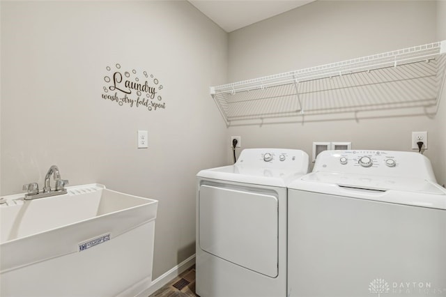 washroom featuring sink, wood-type flooring, and independent washer and dryer