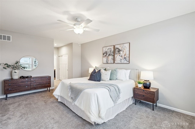 carpeted bedroom with ceiling fan and a closet