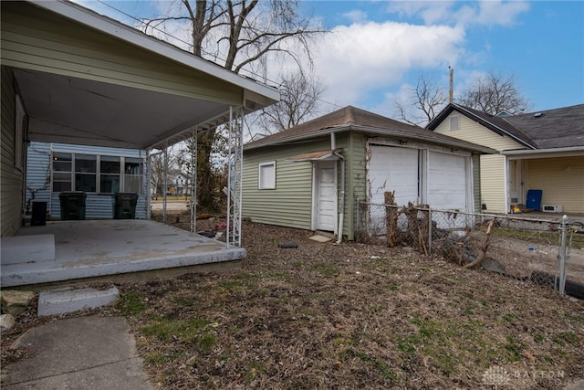 exterior space featuring an outbuilding, a carport, and a garage