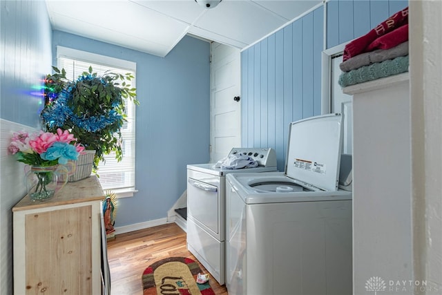 washroom featuring washer and dryer and light hardwood / wood-style flooring