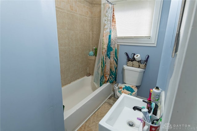 full bathroom featuring toilet, sink, and shower / bath combo with shower curtain