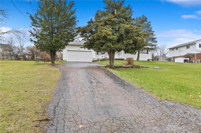 obstructed view of property with a front yard and a garage