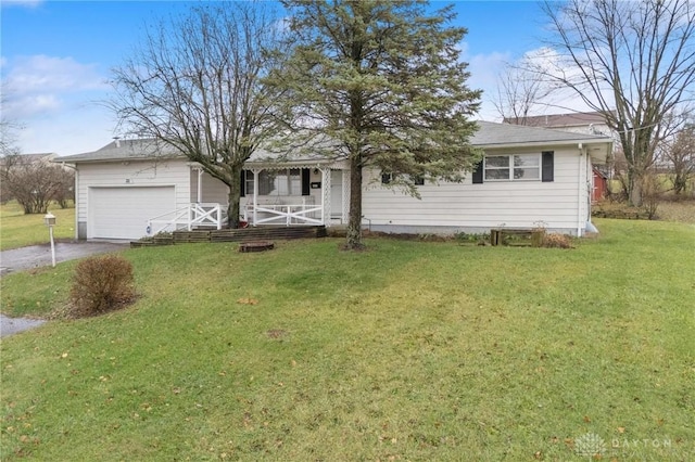 view of front of property with covered porch, a front yard, and a garage