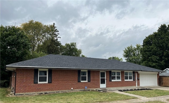 single story home with a front yard and a garage