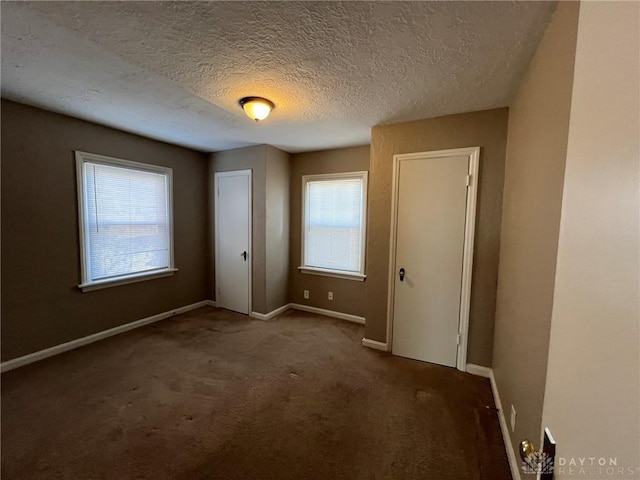 unfurnished bedroom featuring carpet and a textured ceiling