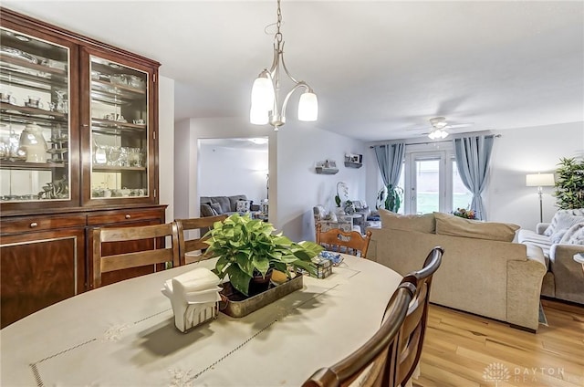 dining space featuring light wood-type flooring and ceiling fan