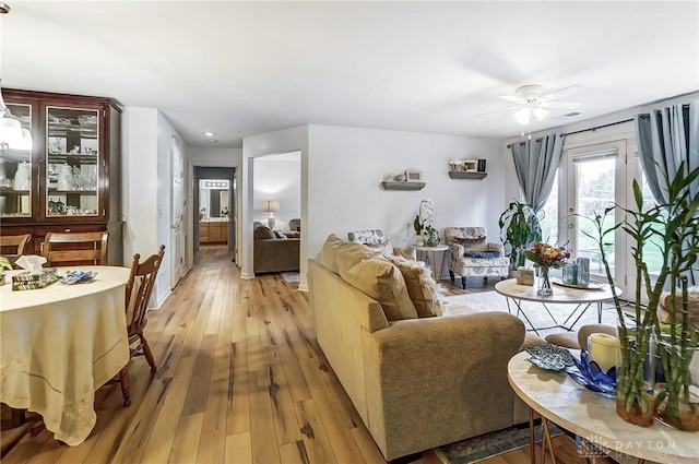 living room featuring ceiling fan and light wood-type flooring