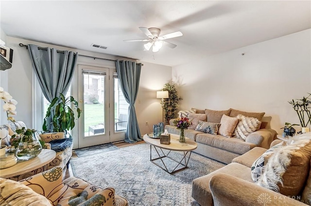 living room featuring ceiling fan and hardwood / wood-style floors