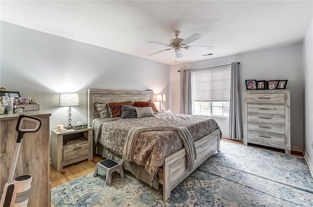 bedroom with ceiling fan and light wood-type flooring