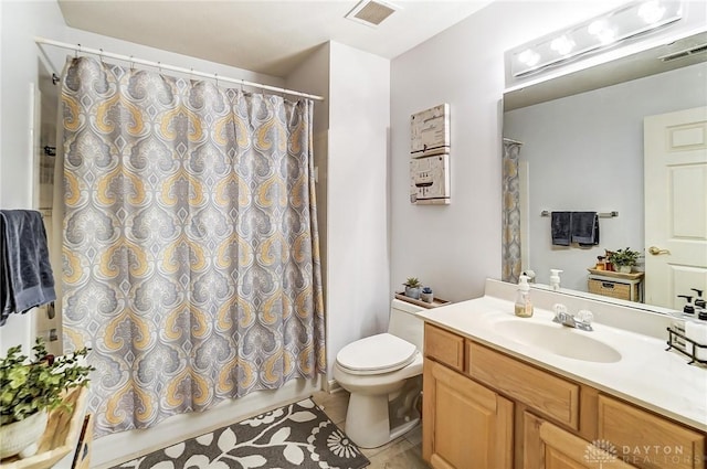 bathroom with tile patterned flooring, a shower with curtain, vanity, and toilet