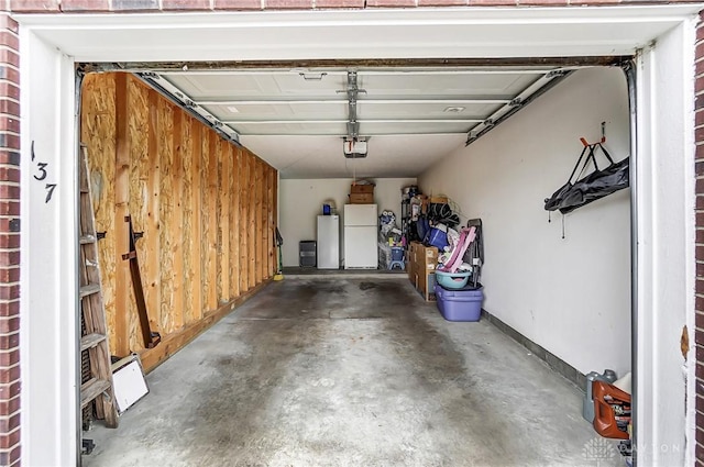 garage featuring white fridge, a garage door opener, fridge, and wooden walls