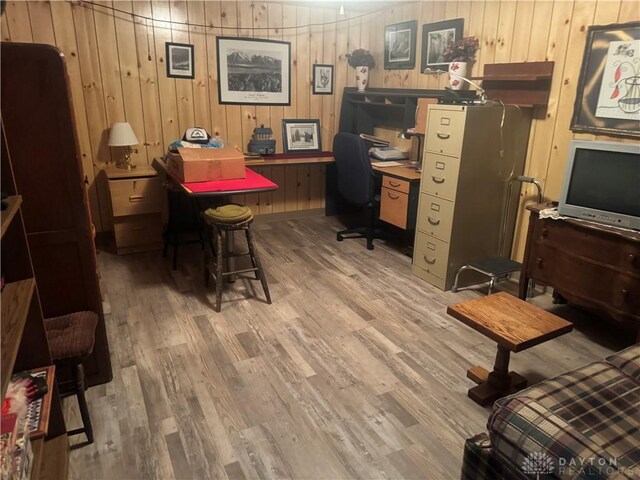 office space featuring wood-type flooring and wooden walls