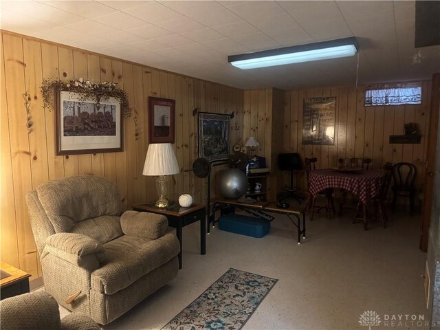 living area featuring wooden walls