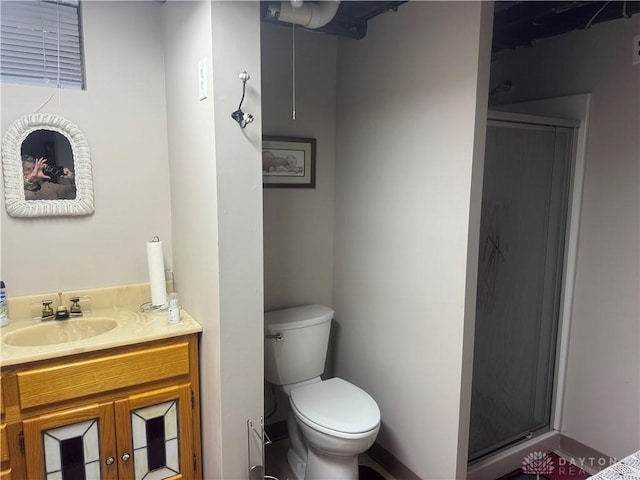 bathroom with vanity, toilet, and an enclosed shower