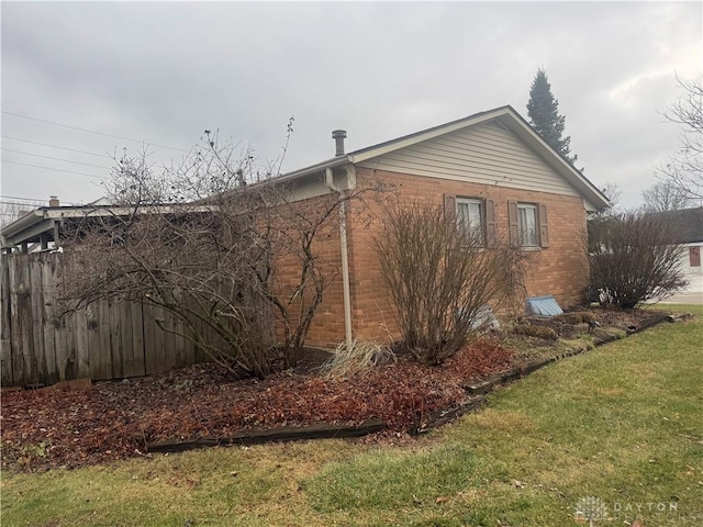 view of side of property with a lawn