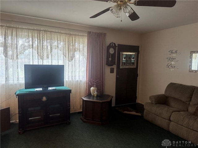 carpeted living room with ceiling fan and a healthy amount of sunlight