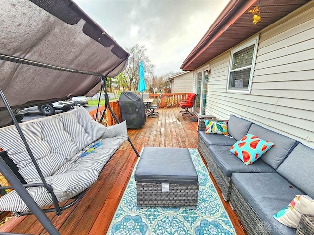 deck with outdoor lounge area and a grill