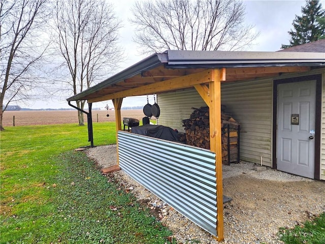 exterior space with a rural view and a yard