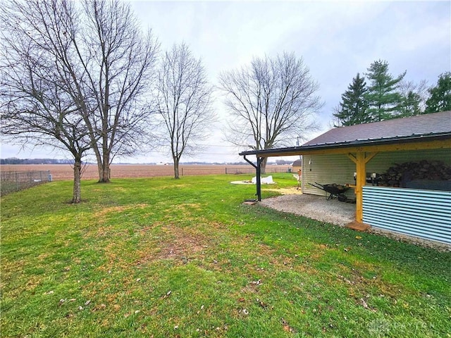 view of yard featuring a rural view and a patio