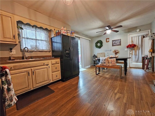 kitchen with ceiling fan, sink, black fridge, dark hardwood / wood-style flooring, and light brown cabinetry