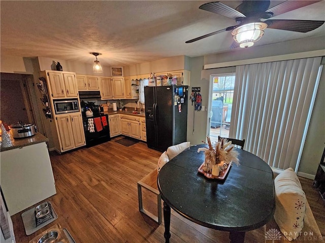 kitchen featuring black appliances, ceiling fan, sink, and dark wood-type flooring