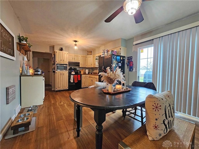 dining area featuring ceiling fan and wood-type flooring