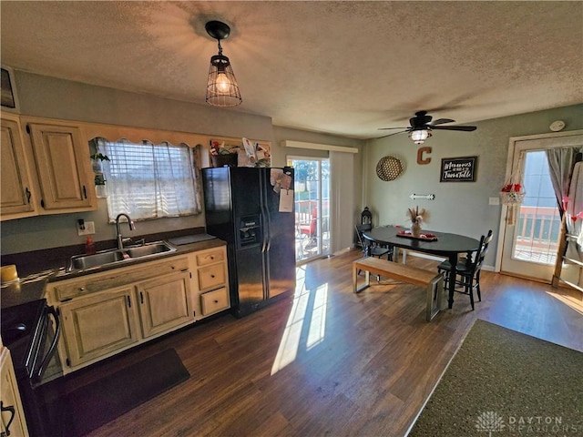 kitchen featuring dark hardwood / wood-style floors, sink, a textured ceiling, and black fridge with ice dispenser