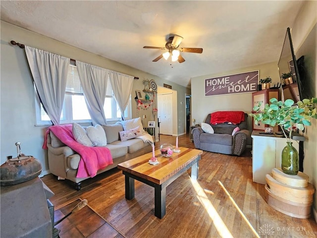 living room featuring dark hardwood / wood-style floors and ceiling fan