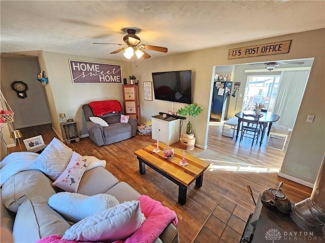 living room with hardwood / wood-style flooring and ceiling fan