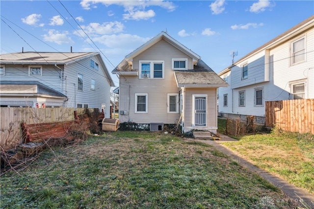 rear view of house with a yard