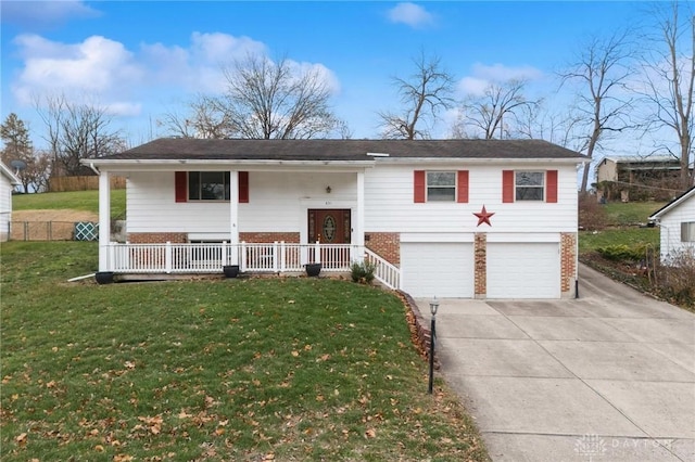 raised ranch featuring a porch, a front yard, and a garage