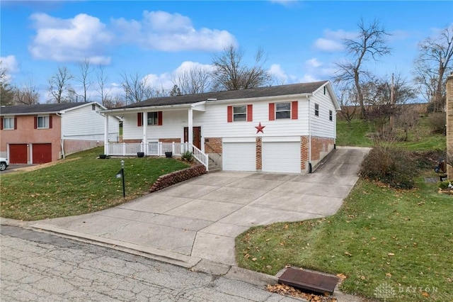 split foyer home with a front lawn, covered porch, and a garage