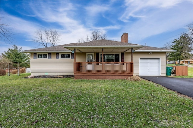 single story home featuring a front lawn, covered porch, and a garage