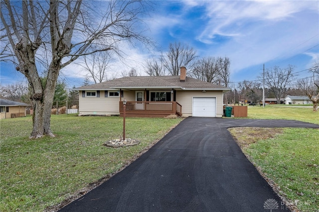 single story home featuring a garage and a front lawn