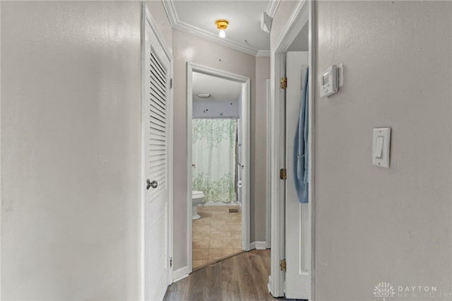 hall with dark hardwood / wood-style floors and ornamental molding