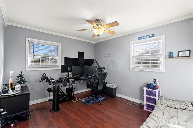 office space featuring dark hardwood / wood-style flooring, a wealth of natural light, crown molding, and ceiling fan