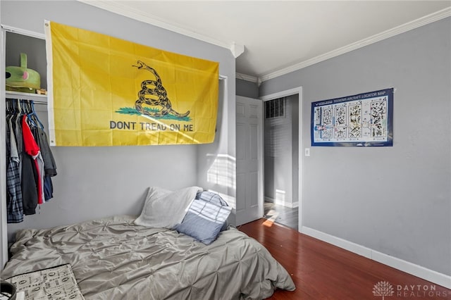 bedroom featuring dark hardwood / wood-style flooring and ornamental molding