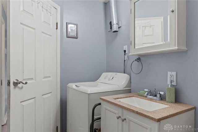 laundry area featuring cabinets, washer / clothes dryer, and sink