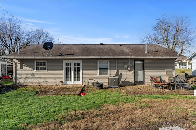 rear view of house featuring a lawn, a wooden deck, and central AC unit