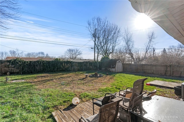 view of yard featuring a storage unit, a deck, and a patio