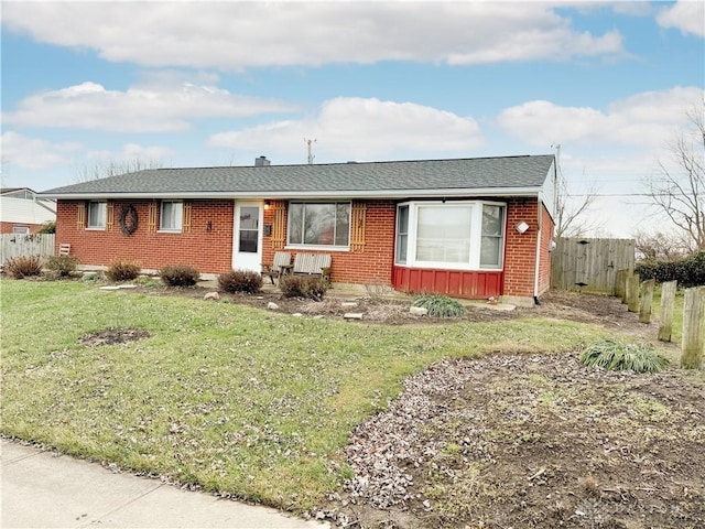 ranch-style home with a front lawn