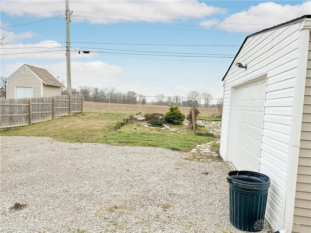 view of yard featuring a garage and an outdoor structure